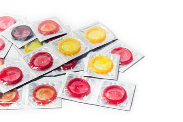 Obraz na płótnie Canvas color condom in female hand isolated on a white background