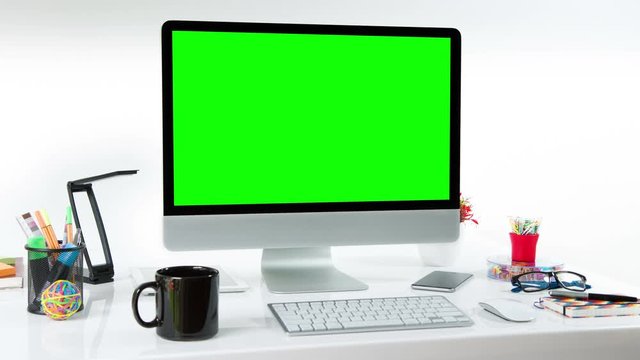 Computer desk with colorful office elements. Lateral dolly. Chroma Key. Perfect to put your own images or videos. Track with perspective corner pin.   
