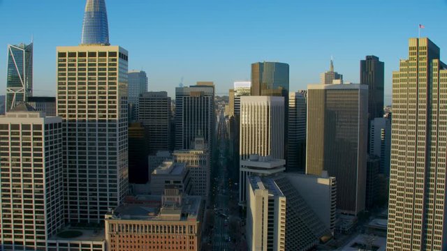 Aerial view of the San Francisco Ferry building with its famous clock tower. Market street and several skyscrapers in the background. Financial District. Shot on Red weapon 8K. California, US
