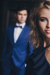 Portrait of stylish couple embracing in european city street. Sensual romantic moment. Fashionable man and woman in love posing with passionate look. Valentines day