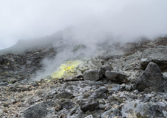 Steaming fumarole covered in sulphur deposits at a slope of Mount Sibayak stratovolcano in Sumatra, Indonesia.