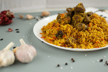 Dish of oriental cuisine - pilaf with lamb in a pan, on a white background.