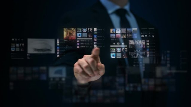 Businessman working on a futuristic holographic interface. Travel from an eye to a tunnel.  