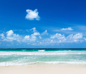 Fototapeta na wymiar Beautiful beach with white sand. Tropical sea with cloudy blue sky . Amazing beach landscape