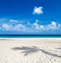 Fototapeta na wymiar Beautiful beach with white sand. Tropical sea with cloudy blue sky . Amazing beach landscape