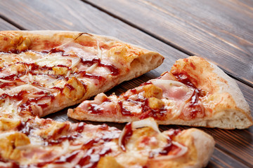 tasty pizza on the wooden background
