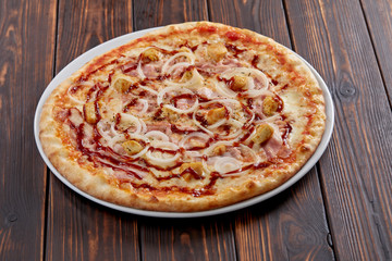tasty pizza on the wooden background
