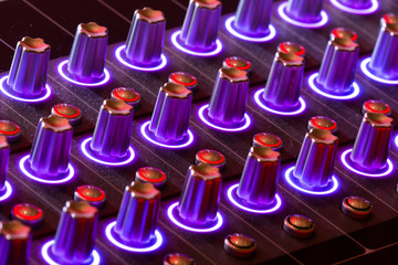 DJ equalizer. Equalizer panel with numerous illuminated knobs, that is used by DJ for volume or...