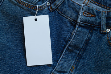 Element of jeans pants with white tag label.
