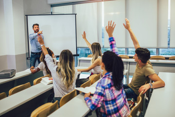Male teacher in university discussion with students
