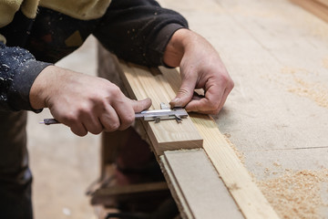 The joiner measures products. Joiner measuring tool at work.