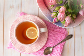 Cup of tea with pink rose. Top view. Concept of love card
