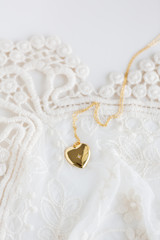 Gold heart necklace on lace