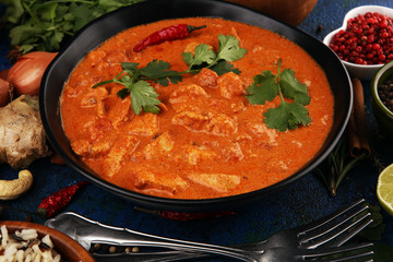 Chicken tikka masala spicy curry meat food in pot with rice and naan bread. indian food