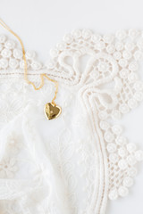 Gold heart necklace on lace
