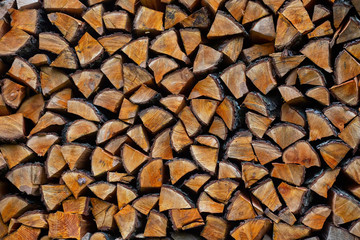 Chopped firewood neatly stacked, texture background