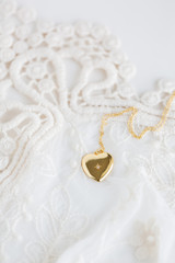 Gold heart necklace on lace