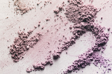 Obraz na płótnie Canvas Crushed eyeshadow blush face powder smeared on white paper background. Pink beige makeup texture