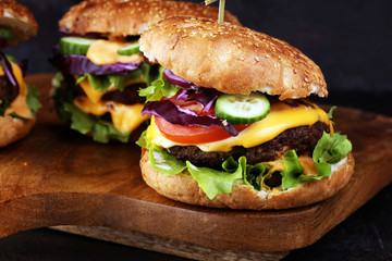Tasty fresh meat burgers with salad and cheese. Homemade angus burger.
