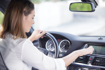 Fototapeta na wymiar woman sitting inside car using gps navigation