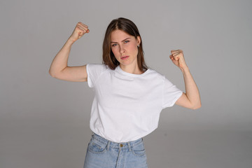 young woman plays feminism on white