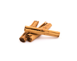 Studio shot three raw dried organic cinnamon sticks isolated on white