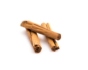 Studio shot three raw dried organic cinnamon sticks isolated on white