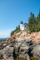 Fototapeta na wymiar White lighthouse along the coast of Maine United States