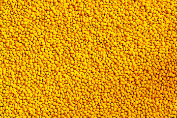Yellow polymer dye in granules, background texture