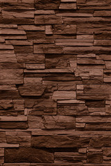 Fasing stone wall of natural stones. Rustic stone wall covering with natural stones.