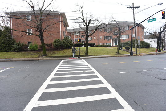 African American pressing the cross button. safety first. A black hand pressing a knob. A cute man trying to cross the road. A man waiting the walk on the zebra crossing