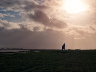 Silhouette of a couple on a walk, Man standing on his knee, Concept purpose.