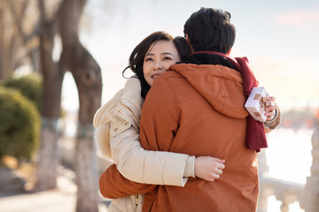 Happy young couple dating outdoors in winter