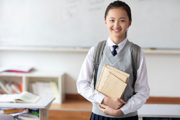 Schoolgirl standing in classroom