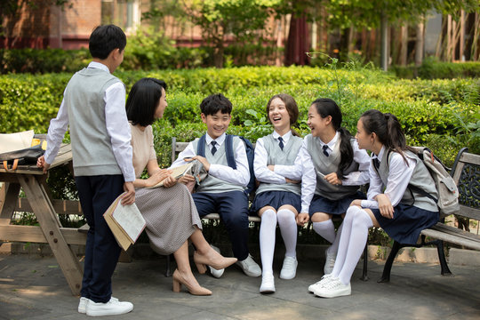 Teacher talking with students on campus