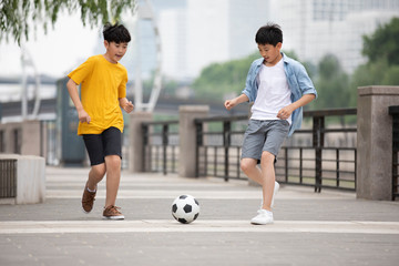 Boys playing football outdoors