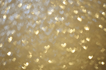 texture background with bokeh hearts of gold color for the holiday Valentine's Day
