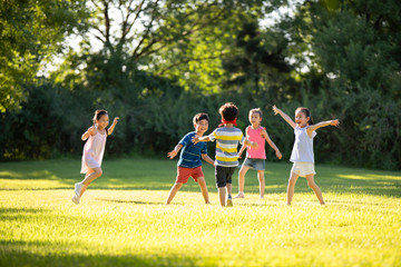 Happy children playing hide and seek on meadow
