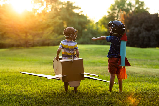 Little boys in costume playing on meadow