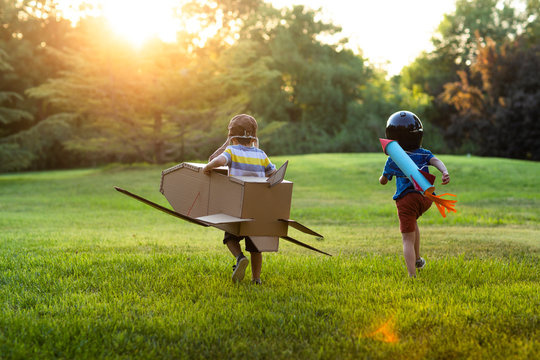 Little boys in costume playing on meadow