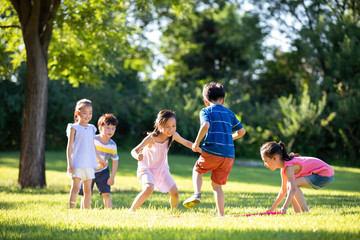 Happy children playing on meadow