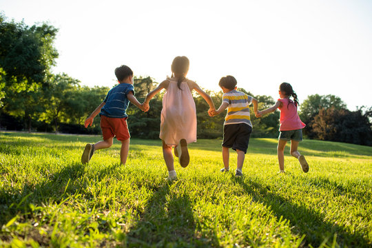 Children running on meadow