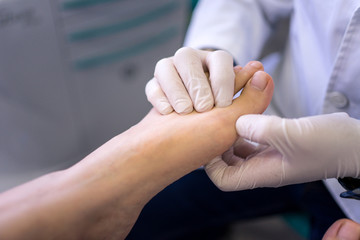 Podiatrist examining and treating patient