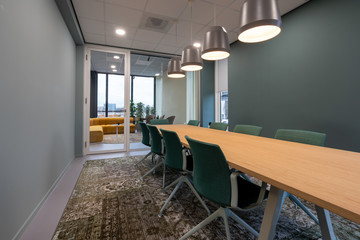 Wooden conference table and chairs in a corporate conference room