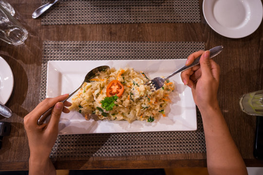 Anonymous lady eating tasty exotic dish at restaurant