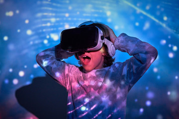 Child wearing virtual glasses at home with colored light effects