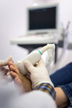 Podiatry doctor using ultrasound scanner