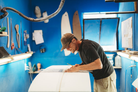 Craftsman making surf board in workshop