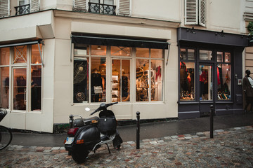 Exterior of boutique with various clothes at inside of building in France