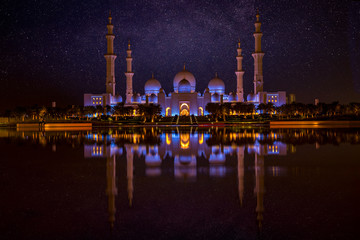 Beautiful night sky with stars over Sheikh Zayed Grand Mosque in Abu Dhabi, United Arab Emirates....